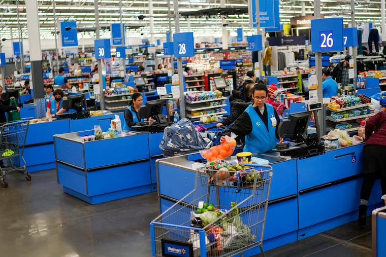 Cashiers process purchases at a Walmart Supercenter in North Bergen, N.J., in 2023. A recent analysis found that the launch of a supercenter store results in an increase in consumer waste of up to 7%.