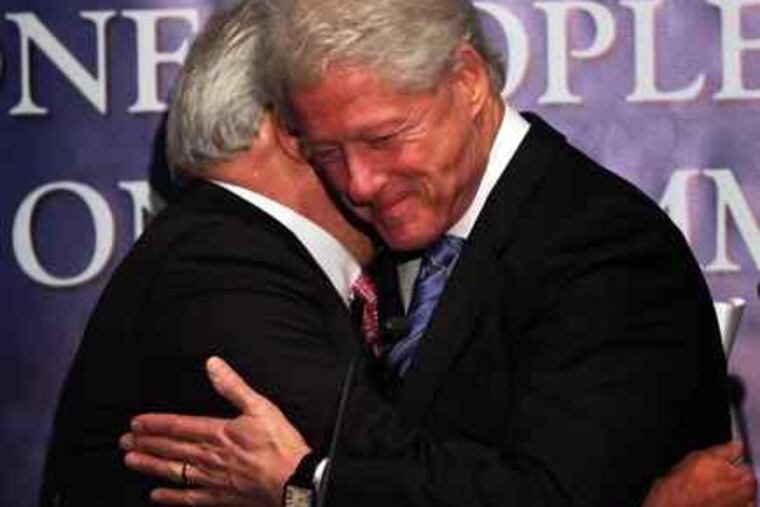 Former President Bill Clinton hugs Leonard Barrack, president of the Jewish Federation of Greater Philadelphia.