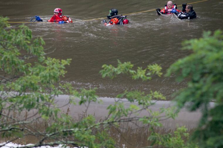Philadelphia police marine unit officers inside Pennypack creek as they search for a missing youth. Philadelphia police marine unit search the Pennypack Creek in Pennypack Park in the northeast section of the city on Monday, July 1, 2013. Early Monday afternoon police and fire responded to reports of a young boy in the river.