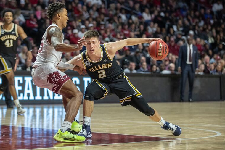 Villanova’s Collin Gillespie tries to drives around Temple guard Nate Pierre-Louis in the second half at the Liacouras Center.