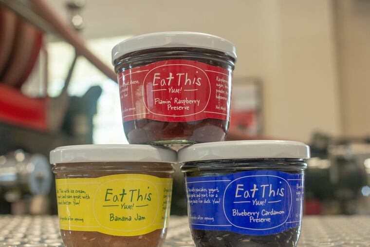 Some of the jam flavors made by Belgian immigrant and volunteer firefighter Gino De Schrijver rest on a firetruck in the firehouse in Erwinna, Pennsylvania in 2018. His side hustle got a jump when his jams got picked up by Whole Foods. In 2014, Oprah featured the jams in her magazine. Now the side hustle is bigger. WILLIAM THOMAS CAIN / For The Inquirer