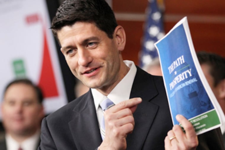 House Budget Committee Chairman Rep. Paul Ryan, R-Wis., holds up a copy of his budget plan entitled "The Path to Prosperity," Tuesday, March 20, 2012, during a news conference on Capitol Hill in Washington. (AP Photo/Jacquelyn Martin)
