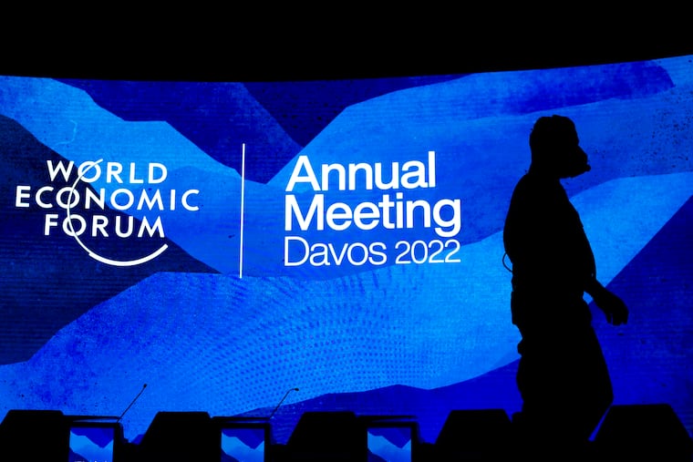 Workers set the stage prior to the annual meeting of the World Economic Forum, in Davos, Switzerland, Sunday, May 22, 2022. The World Economic Forum reported on Wednesday, July 13, 2022, that the cost-of-living crisis, sparked in part by higher fuel and food prices, is expected to hit women the hardest.