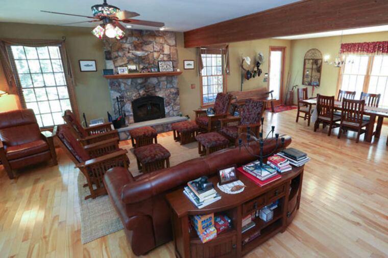The living room and dining room of the Cottones' Lake Wallenpaupack vacation house. STEVEN M. FALK / Staff Photographer