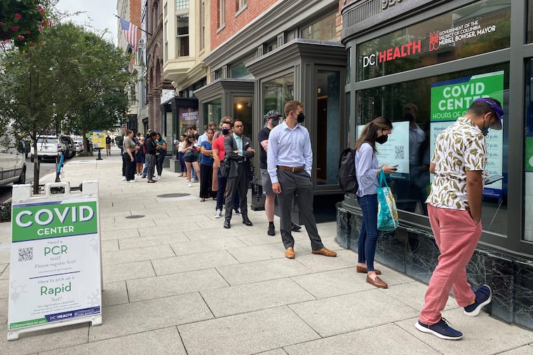 People wait in line in Washington, D.C., earlier this month to get a reconfigured coronavirus booster shot designed to offer greater protection against omicron subvariants.