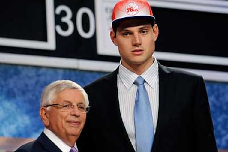 Nikola Vucevic poses with NBA Commissioner David Stern after being selected by the Sixers in the first round. (Bill Kostroun/AP)