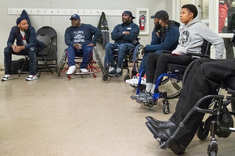 Mykkia McDonald, 24, right, attends the paralyzed gunshot survivors group at the Carousel House in West Philadelphia on Monday evening, Nov. 18, 2019. McDonald attended for the first time, and is the only woman so far to join the group. She was shot 10 times around seven months ago while she was out to get food in North Philadelphia.