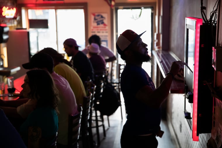 At Bonnie's Capistrano bar, picking out some songs on the juke box.