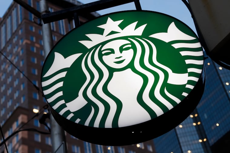 A Starbucks sign hangs outside a Starbucks coffee shop in downtown Pittsburgh in 2019.
