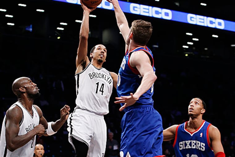 Nets point guard Shaun Livingston shoots over the Sixers' Spencer Hawes in the first half. (Kathy Willens/AP)