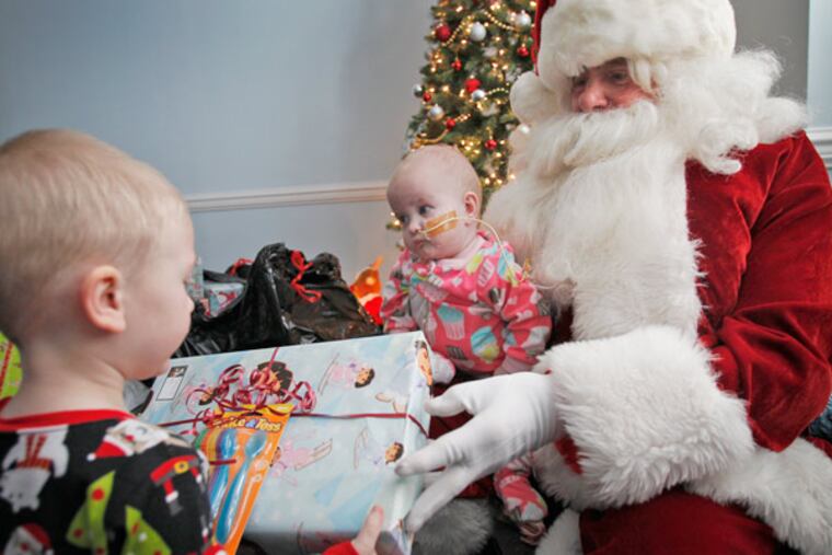 Joseph Hassman, a physician, visits Camden's Ronald McDonald House - here with Owen Tucker, 2, and his sister Allison, 9 months, of Watertown, N.J. (Alejandro A. Alvarez / Staff Photographer)