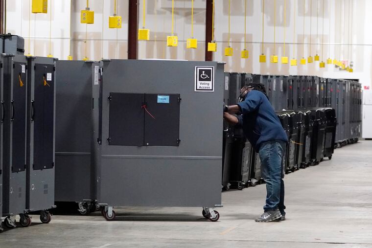 A worker returns voting machines to storage in Atlanta, Ga., on Nov. 4, 2020.