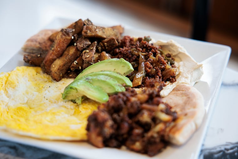 The The N-Liberties includes hummus topped with jalapeño, sausage, avocado, caramelized onions & fried eggs at Cafe La Maude on Tuesday, Feb. 17, 2026 in Philadelphia.