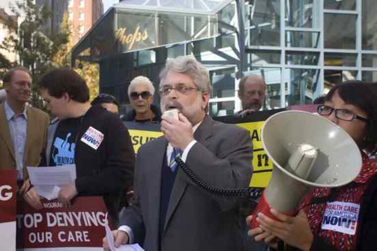 Marc Stier (center) leads a protest outsideCigna Corp. headquarters. Stier, whowas arrested for refusingto move, isan officialof the group Health Care for America Now.