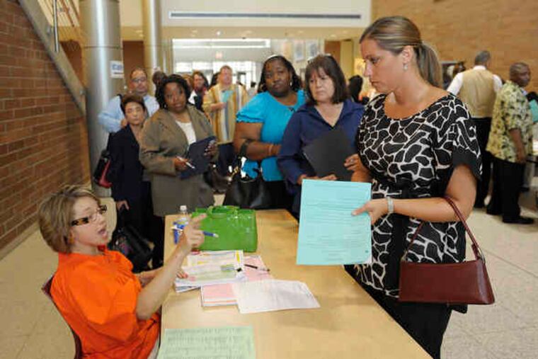 Special-education administrator Lois Hussain gives tips to Meghan Flowers, a teacher, before she goes out on job interviews in Detroit, one of the nation's hardest-hit areas.
