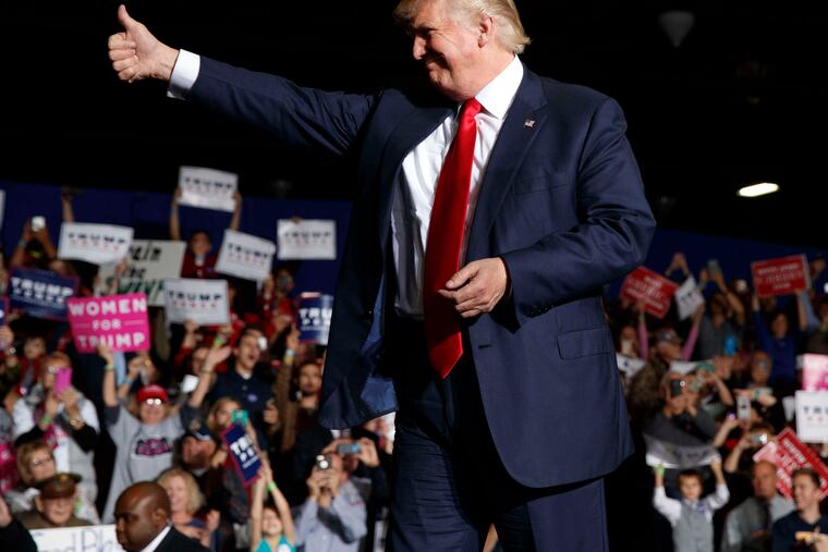 Donald Trump arrives at a rally in Geneva, Ohio. He hailed the news of the latest FBI probe, telling supporters at a New Hampshire rally that "perhaps, finally, justice will be done."