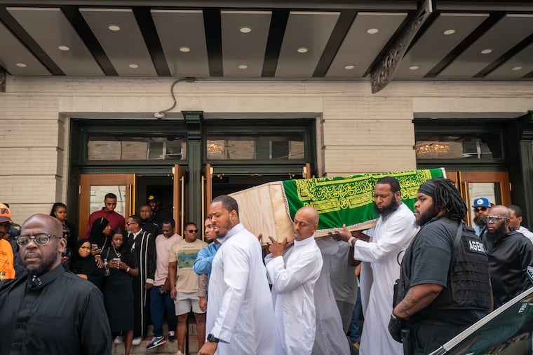 Pallbearers, including Gillie da King (center), carry the coffin of Devin Spady after the Janazah funeral prayer at the Met Philadelphia on Monday morning.