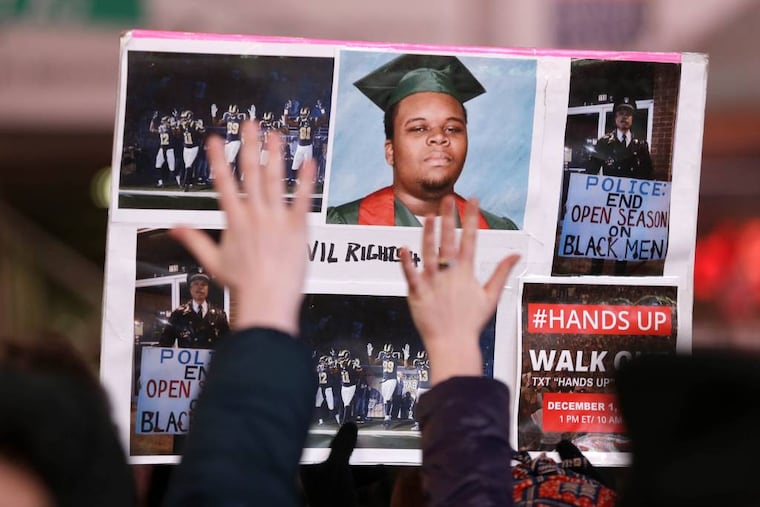 FILE- In this Dec. 3, 2014 file photo, people participate in a protest in response to the grand jury's decision in the Eric Garner case in Times Square in New York. (AP Photo/Seth Wenig, File)