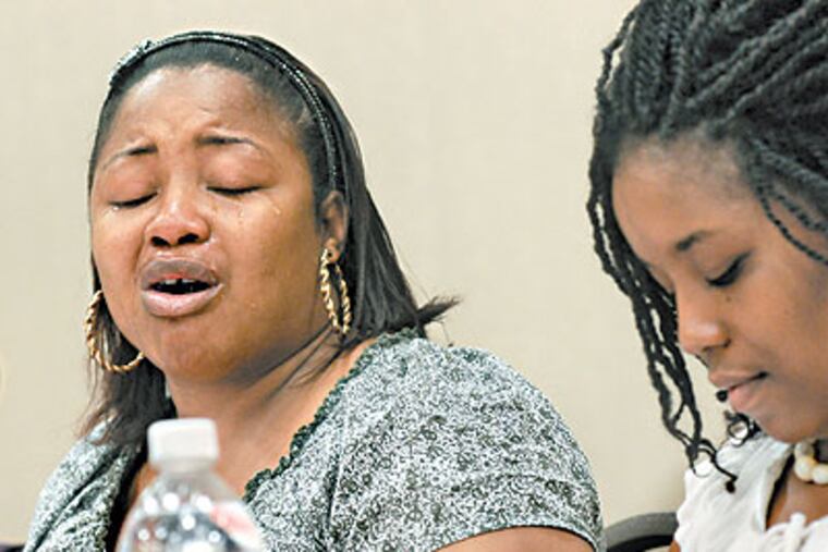 At Rutgers Camden, Tisha Oliver cries as she talks about her experience as the child of an incarcerated parent. At right is her sister, Pennie Oliver. (April Saul / Staff Photographer)