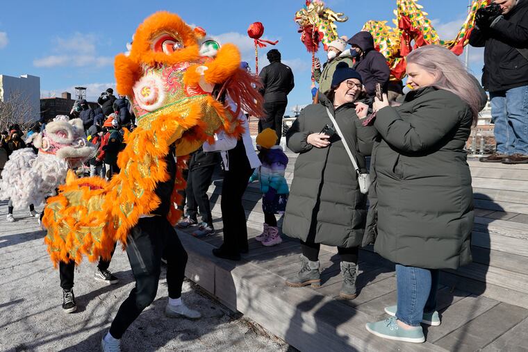 The lions dance during the outdoor Lunar New Year celebration at the Philly Rail Park, on Saturday. The event was presented with the Asian Arts Initiative, the Philadelphia Suns, and the Philadelphia Chinatown Development Corp.