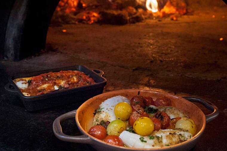 Crespelle baked pasta and oven-roasted calamari with cherry tomatoes at Brigantessa, 1520 E. Passyunk Ave., from the Le Virt team. (RON TARVER / Staff Photographer)