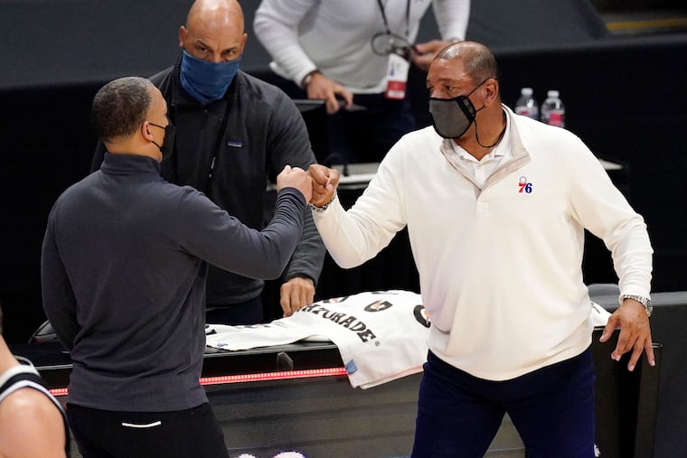 Los Angeles Clippers coach Tyronn Lue, left, and 76ers head coach Doc Rivers greeted each other after their March 27 game.