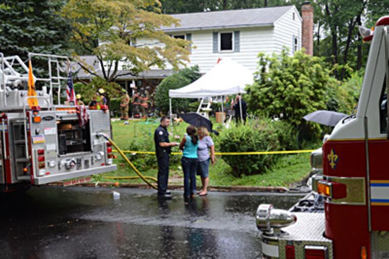 Fire investigator interviews two women about Robert O'Neill, 85, and his wife, Irene, 68, who died in a fire at their West Goshen home. The blaze was electrical and accidental, police said, but "the hoarding contributed more fuel to burn." CLEM MURRAY / Staff Photographer