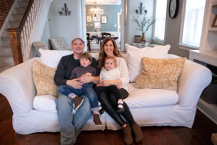 Dan and Katie Mickelson with their two children Noah, 4, and Molly, 2, in the living room of their Bridesburg home.