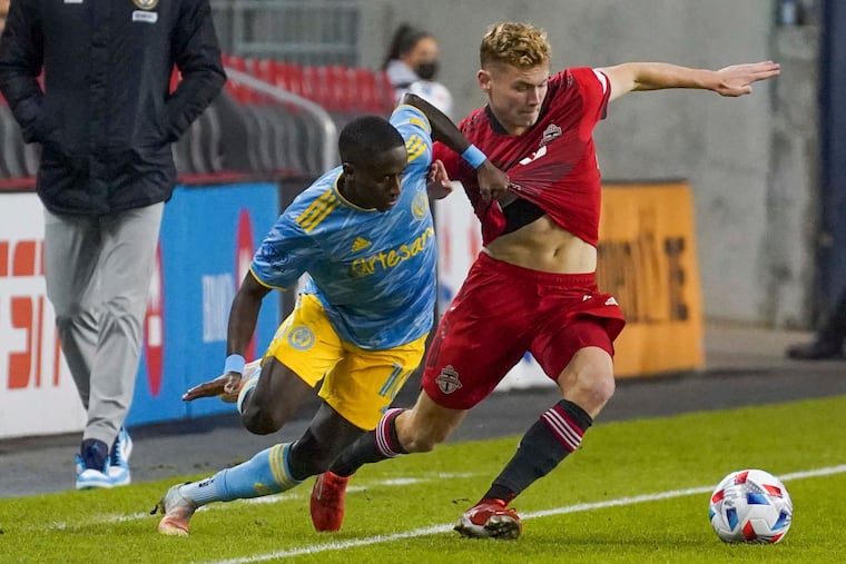 Union midfielder Jamiro Monteiro (left) battles with Toronto FC forward Jacob Shaffelburg during the first half.