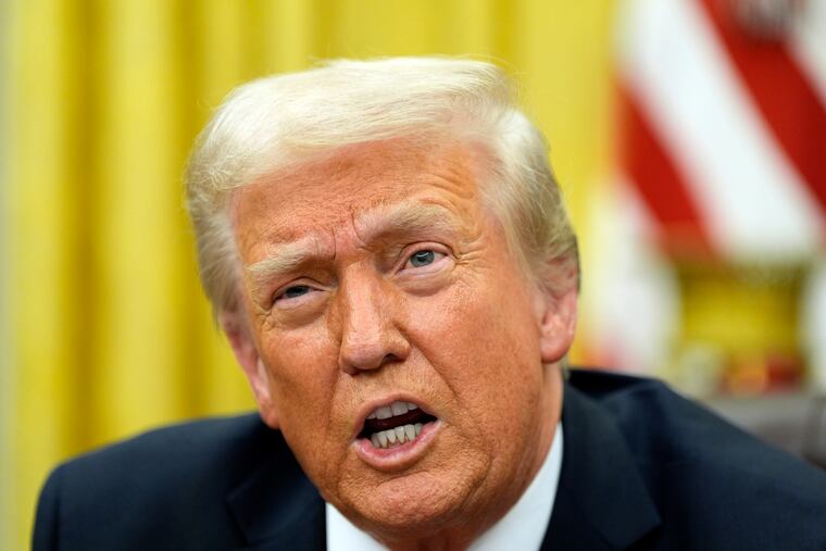 President Donald Trump speaks with reporters as he signs executive orders in the Oval Office on Monday, Feb. 10, 2025.