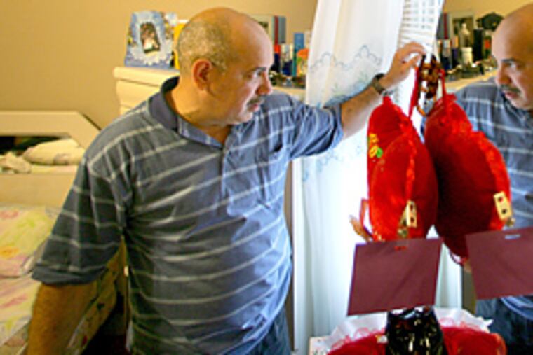 Lorenzo Martinez stares from his bedroom window, where he once though he saw an Iraqi sniper across the street. (David Swanson/Inquirer)