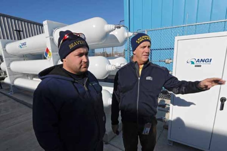 Kevin Kilpatrick (right), planning mamnager for River Valley Transit in Williamsport, talks Nov. 20, 2013 with Eric Beaver, compressed natural gas engineer for Beavers Petroleum Equipment Company of Horseheads, NY, about the $6.5 million CNG filling station almost ready to come online at the RVT depot. RVT is transitioning its fleet of 29 buses to CNG fuel and will allow other businesses and private citizens to fuel CNG vehicles at its filling station, generating another income stream for the public transit company. ( CLEM MURRAY / Staff Photographer )