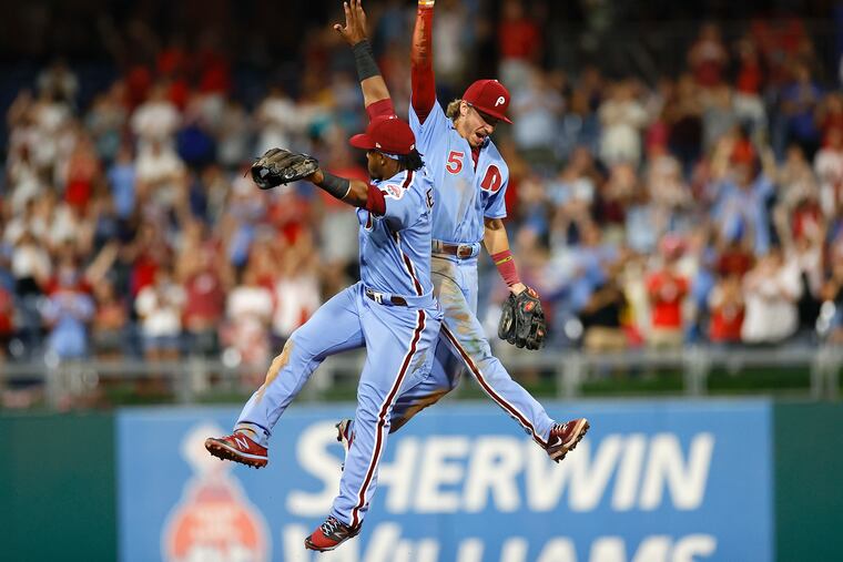 Phillies shortstop Bryson Stott and second baseman Jean Segura celebrate the Phillies 4-0 win over the Cincinnati Reds on Thursday.