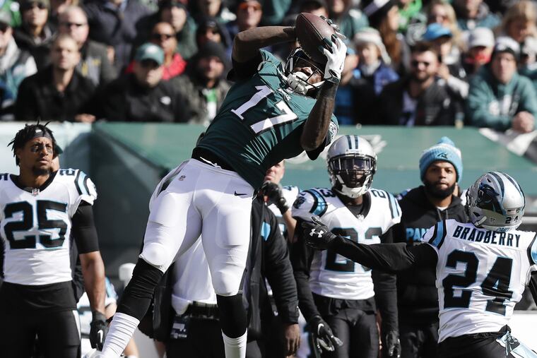 Eagles wide receiver Alshon Jeffery catches the football past Carolina Panthers cornerback James Bradberry during the second-quarter on Sunday, October 21, 2018 in Philadelphia. YONG KIM / Staff Photographer