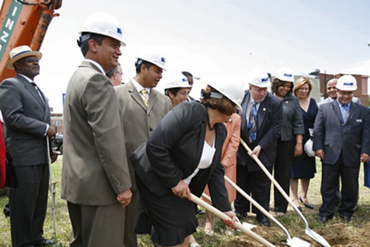 Carlos Castro (second from left) participates in the groundbreaking for the new Puerto Rican community center in Camden. “My heart and feelings are in the city,” Castro said. (Eric Mencher / Staff Photographer)