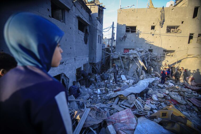 Palestinians search the rubble of a destroyed building following an Israeli airstrike in the Nuseirat refugee camp, central Gaza, on Wednesday.