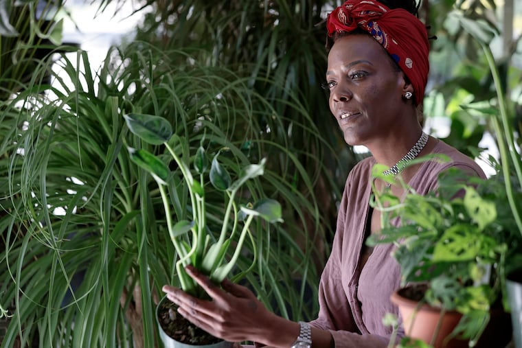 Yolanda Palmer tends to plants at her shop Foliage Chestnut Hill.