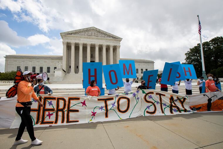 Deferred Action for Childhood Arrivals (DACA) recipient Roberto Martinez, left, celebrates with other DACA recipients in front of the Supreme Court on Thursday in Washington. The high court ruled that President Donald Trump improperly ended the DACA program in 2017.