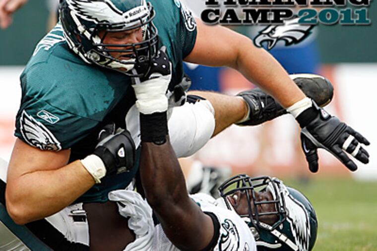 Danny Watkins and Moises Fokou get into it during practice on Saturday morning. (Yong Kim/Staff Photographer)