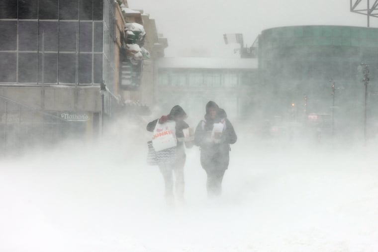 Two people brave the snow and wind in Atlantic City on Jan. 29. 2022, the last time that Philly recorded an inch of snow.