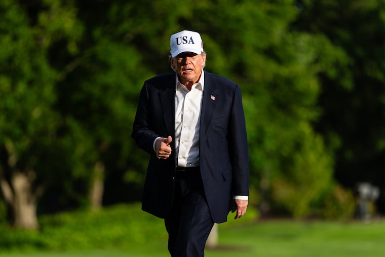 President Donald Trump walks on the South Lawn of the White House on Friday.