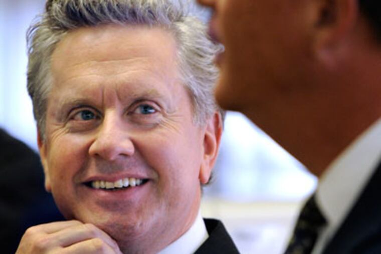 Newly-hired Faith in the Future CEO Samuel Casey Carter (cq-left) is introduced to students in a classroom at SS. John Neumann and Maria Goretti High School by H. Edward Hanway (cq-right), the philanthropy's chairman, during a tour of the school October 8, 2012. ( TOM GRALISH / Staff Photographer )