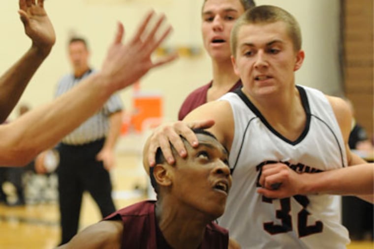 William Tennent High's Corey Hamlet palms the head of Abington High's Anthony Durham during the game at Tennent Jan. 8, 2013. Hamlet was called for the foul and Durham sank one of two free throws. ( CLEM MURRAY / Staff Photographer )