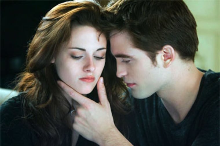 Kristen Stewart and Robert Pattinson as the newlyweds. ANDREW COOPER / Summit Entertainment