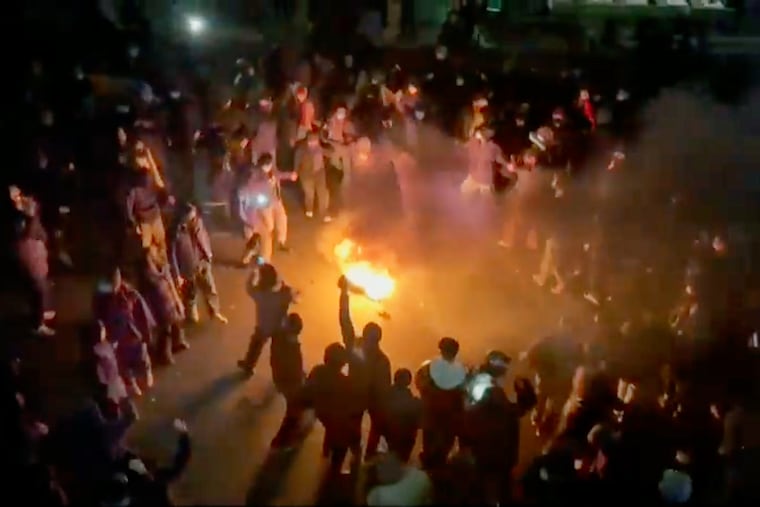 This frame grab from footage circulating on social media shows protesters dancing and cheering around a bonfire as they take to the streets despite an intensifying crackdown as the Islamic Republic remains cut off from the rest of the world, in Tehran, Iran, Friday, Jan. 9, 2026.