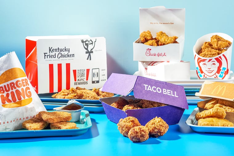 Chicken nuggets, clockwise from center: Taco Bell, Burger King, KFC, Chick-fil-A, Wendy's, and McDonald's. MUST CREDIT: Rey Lopez for the Washington Post / food styling by Carolyn Robb for the Washington Post