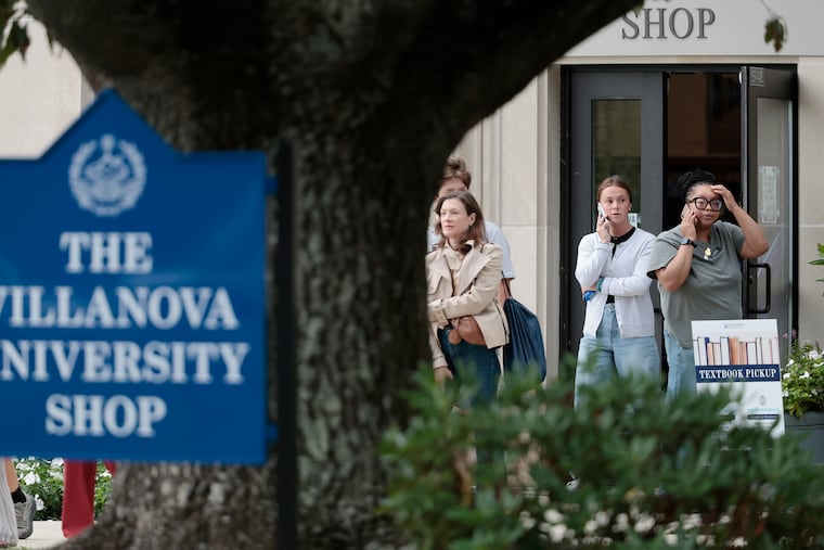People who had been sheltering in place inside the Villanova University Shop come outside Thursday after police determined that an active shooter notification was a hoax.