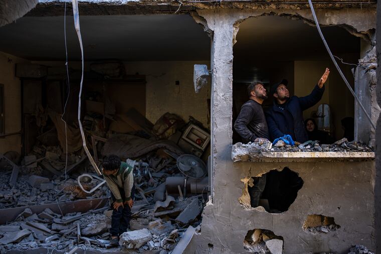 Palestinians look at the destruction after an Israeli strike in Rafah, southern Gaza Strip on Thursday, Feb. 8, 2024.