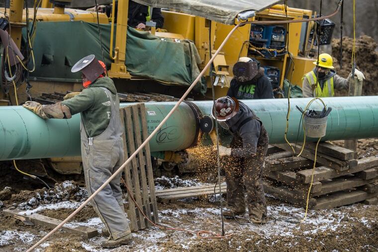 Workers install 20-inch epoxy-coated pipes on the Mariner East 2 pipeline in Washington County, Pa.