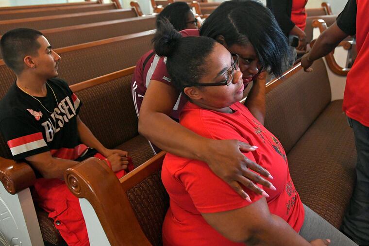 Shevona Overton, seated, gets a hug from her aunt Jennifer Overton during a news conference, Monday, Aug. 12, 2019, at Second Baptist Church, on E. 26th Street, in Erie, Pa. Shevona Overton lost her four children in a fatal fire a day earlier at a home child care center in Erie. A fifth child also died and at least two others were injured in the fire.